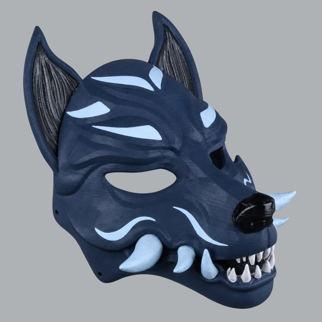 Kitsune fox mask with fangs in Dark Indigo / Ice Blue — three-quarter view facing right