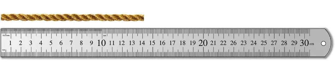 The measured string placed straight along a ruler to read its length.
